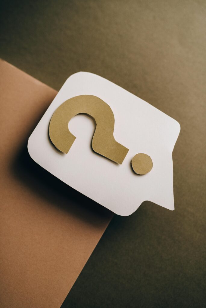 Artistic paper craft of a question mark on neutral background. Ideal for concept themes.